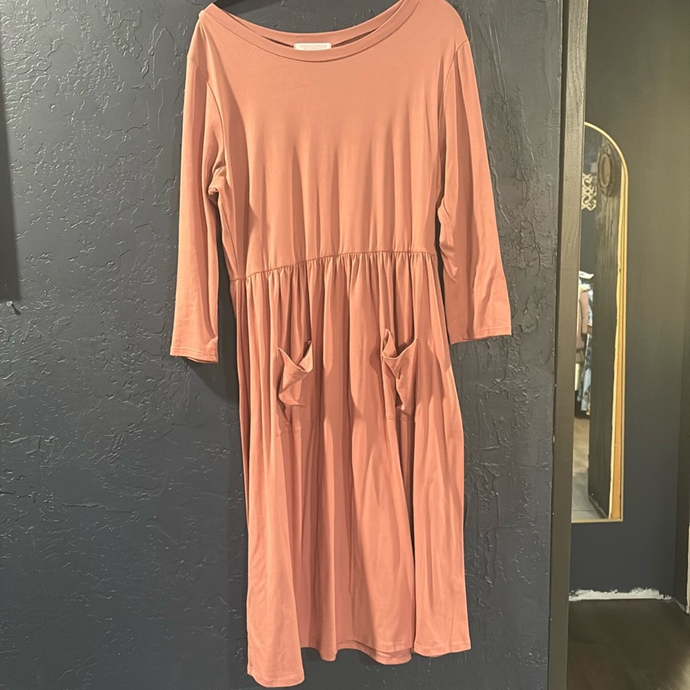 Beautiful pinky mauve dress with pockets on front.
